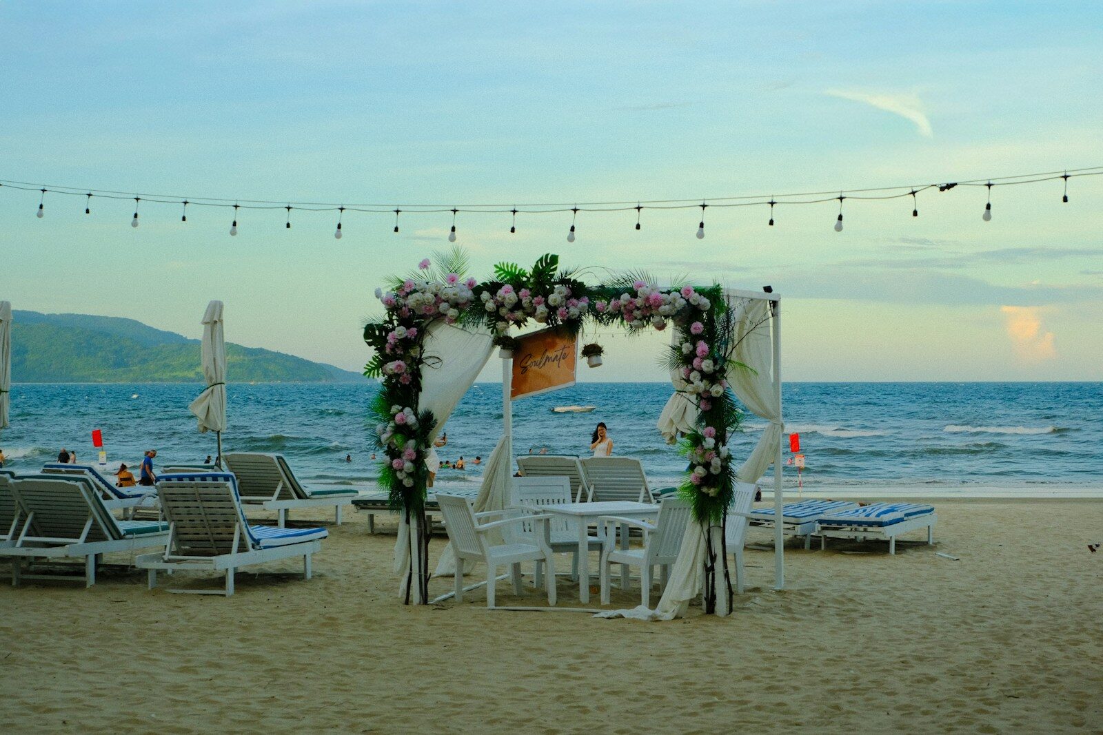 Wedding arch on a sandy beach with ocean background